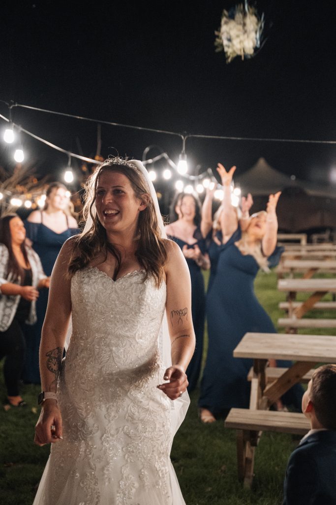 Bride tossing her boquet of flowers.