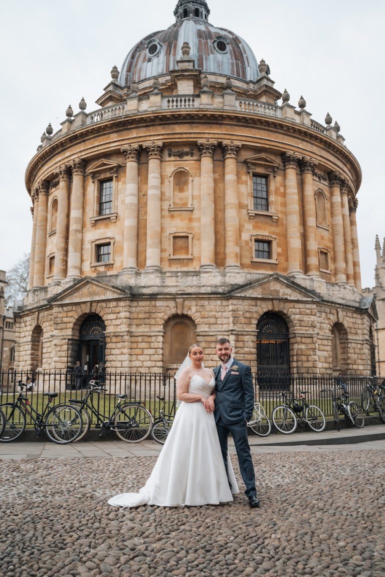 Bride and groom stood in front of the Radcliffe Camera in Oxford