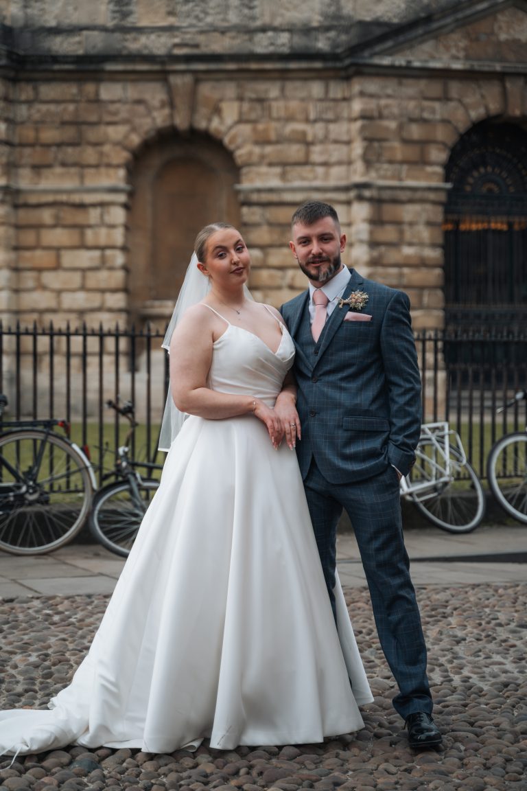 Bride and Groom standing in front of the Radcliffe Camera in Oxford City centre.
