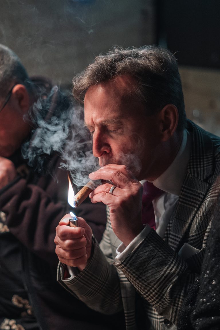A man lighting a cigar