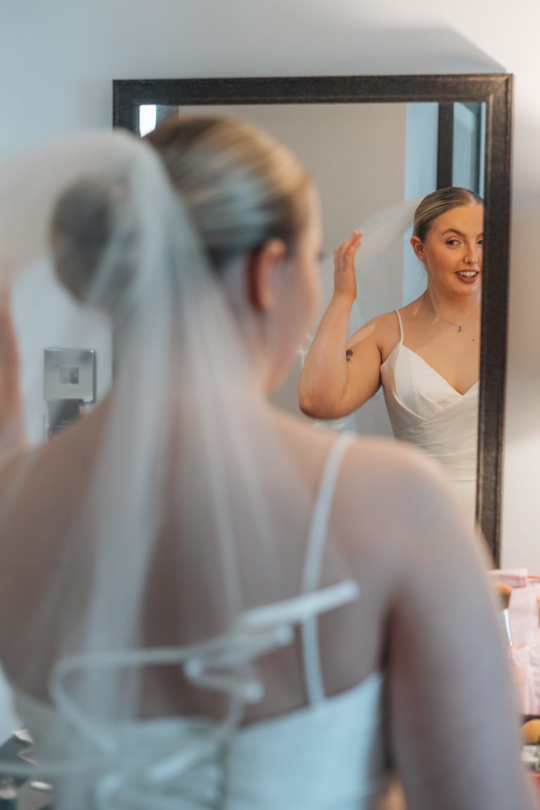 Looking into a window and seeing the bride looking back at herself.