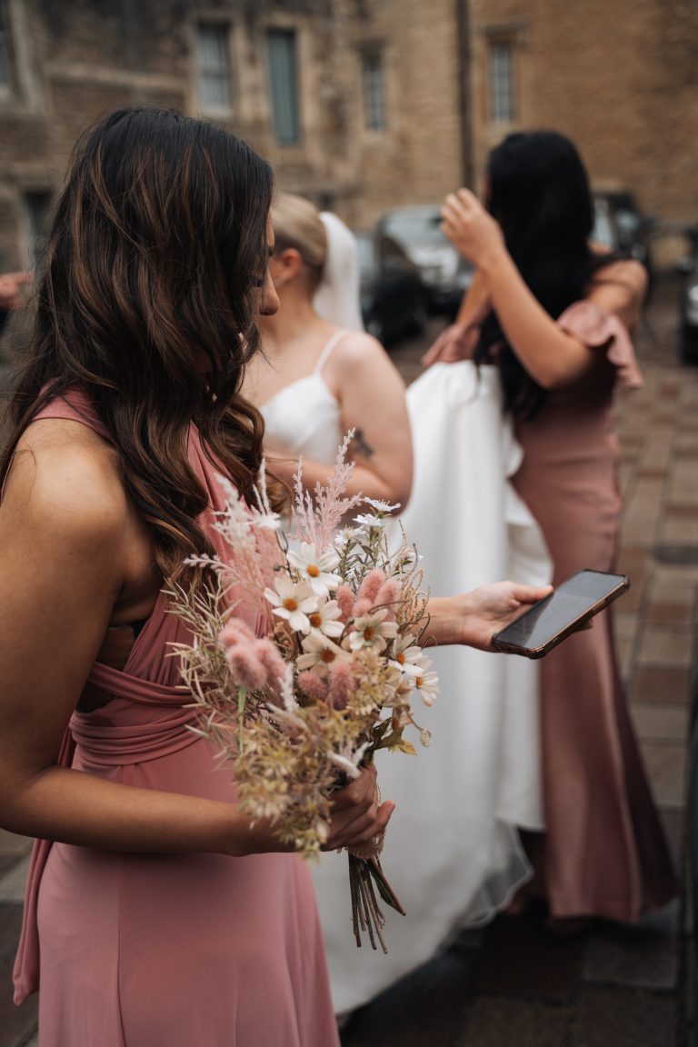 Bridesmaid checking her phone